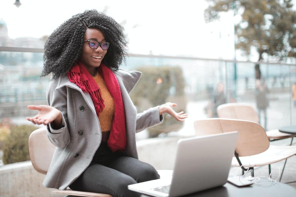 cheerful surprised woman with laptop by andrea piacquadio via pexels