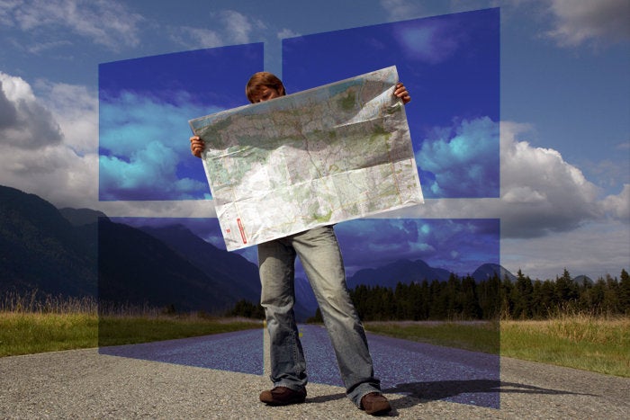 man holding map with windows 10 logo in background